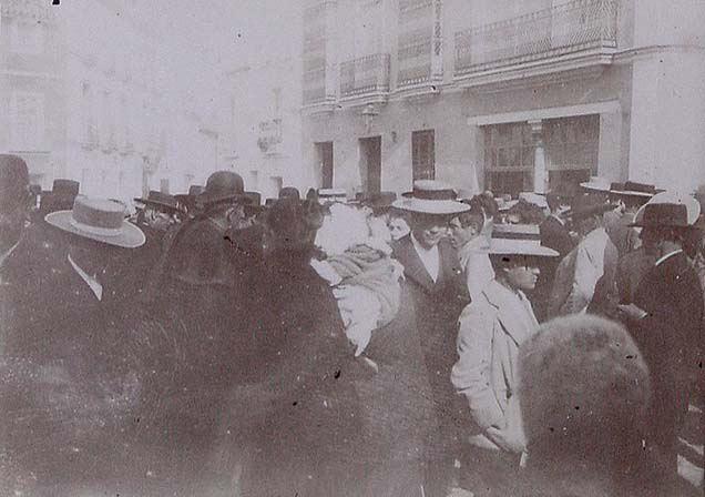 (Personas con trajes típicos a la entrada de una iglesia de Sevilla)