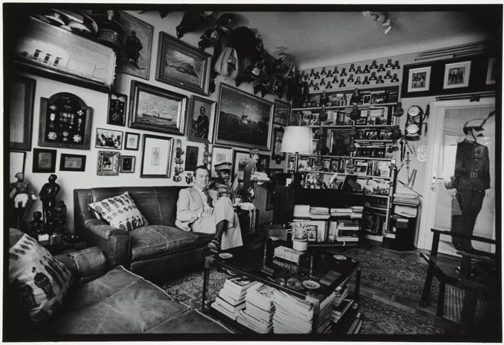 Retrato de un hombre en una habitación con colección de artículos militares