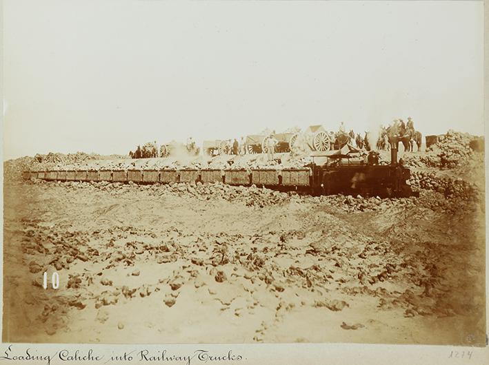 Pampa and oficina views. Loading Caliche into railway trucks