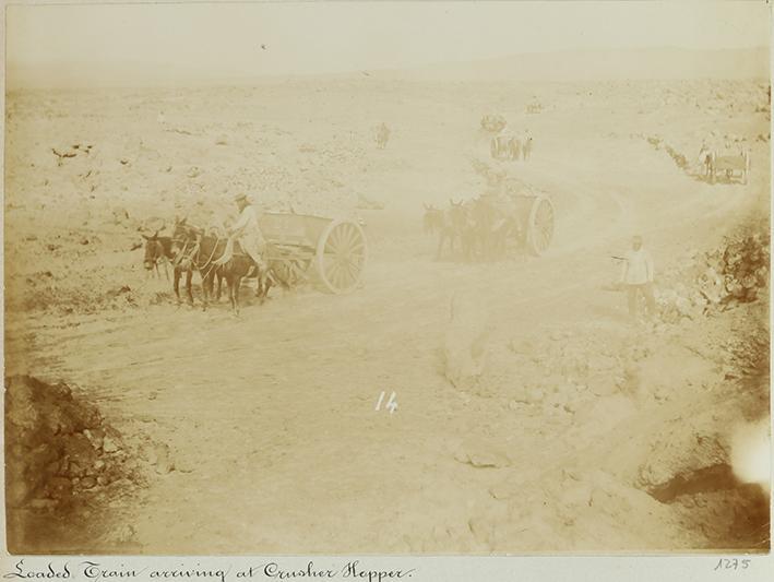 Pampa and oficina views. Loaded train arriving at crusher Hopper