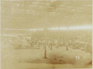 Views in Iquique. Warehouse. Interior. Loading a car for shipment